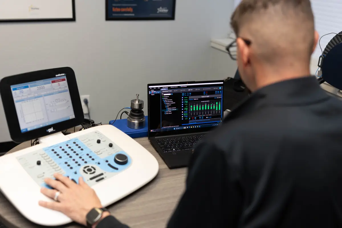 Over-shoulder view of calibration equipment and software during an audiometer calibration